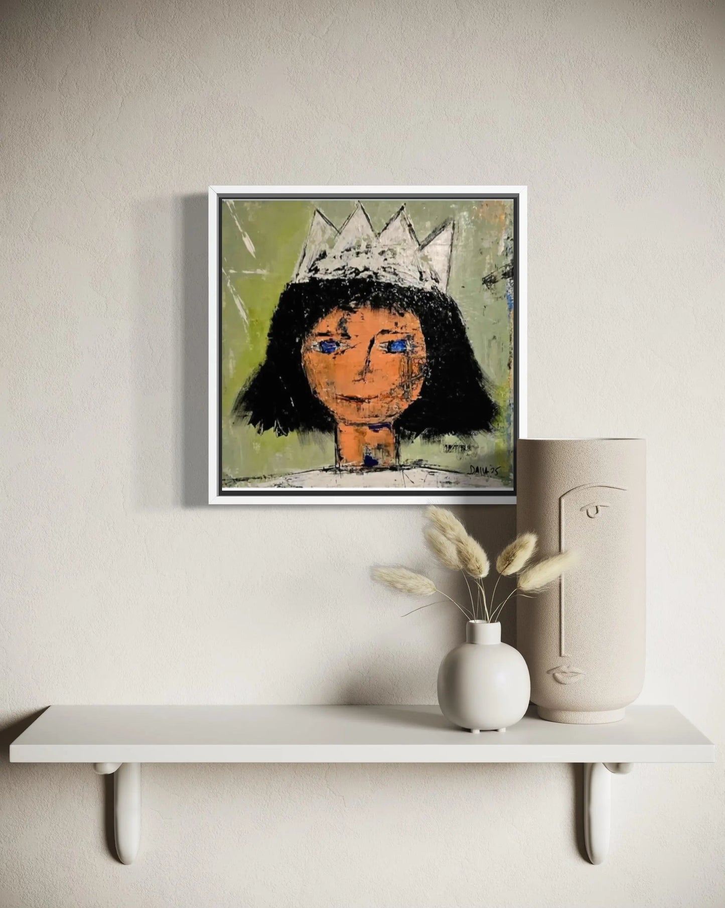Dalla myndlist, Untitled. Framed abstract artwork of a stylized face with a crown on a wall above a white shelf with decorative items.