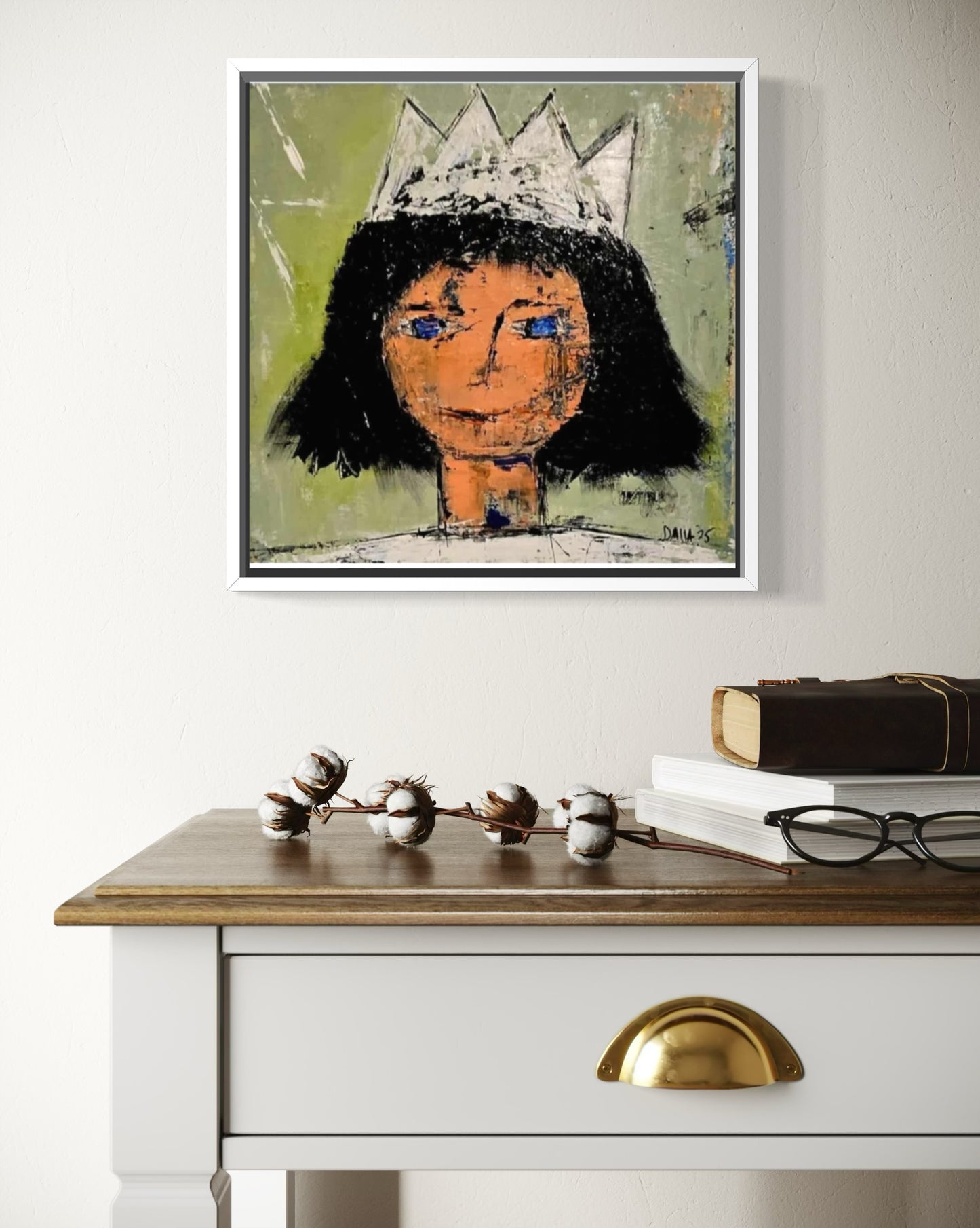 Dalla myndlist, Untitled. Framed abstract artwork of a person with a crown on a wall above a white dresser with gold handles.
