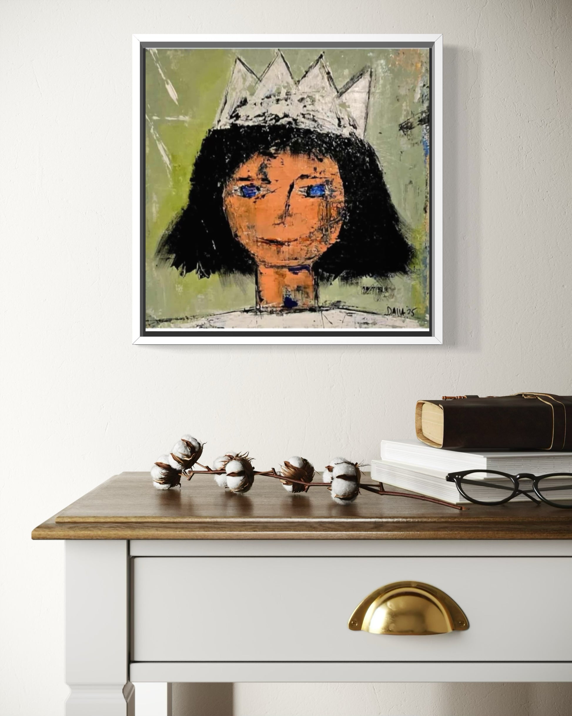 Dalla myndlist, Untitled. Framed abstract artwork of a person with a crown on a wall above a white dresser with gold handles.